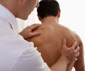 Neurologist examines a patient with symptoms of cervical osteochondrosis